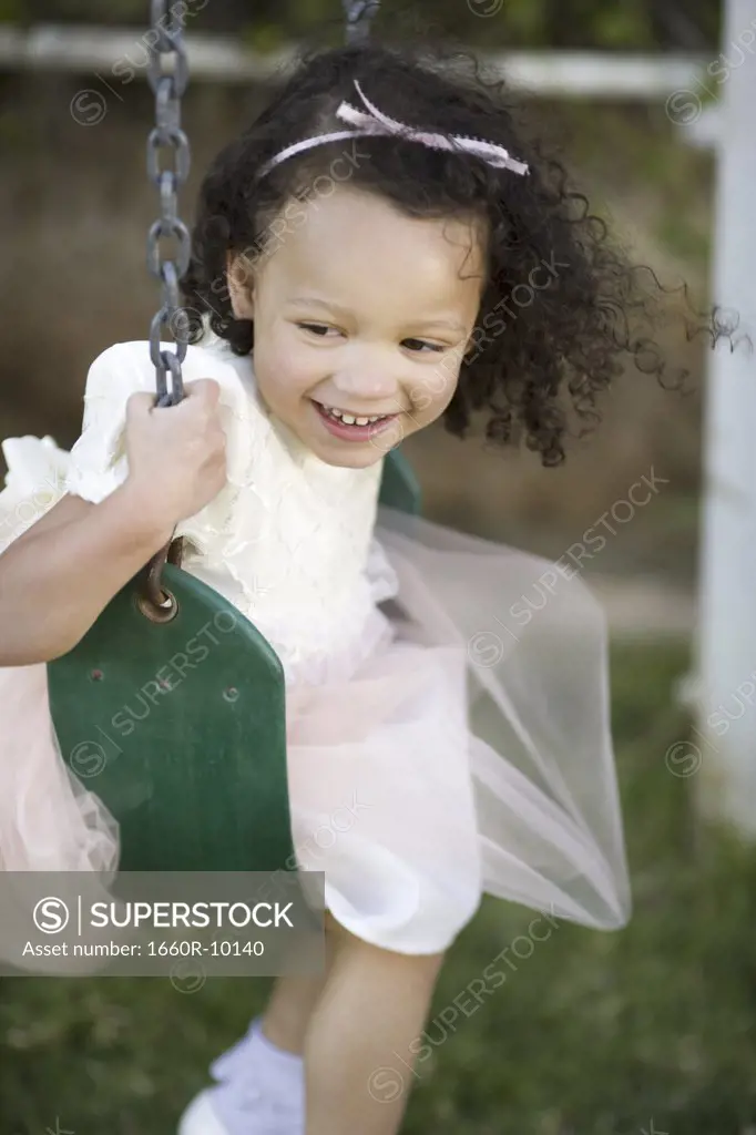 Close-up of a girl on a swing