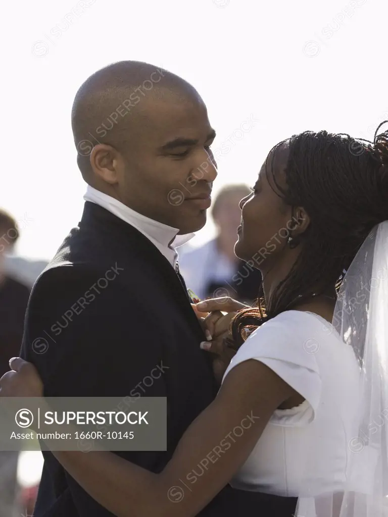 Profile of a bride and a groom dancing