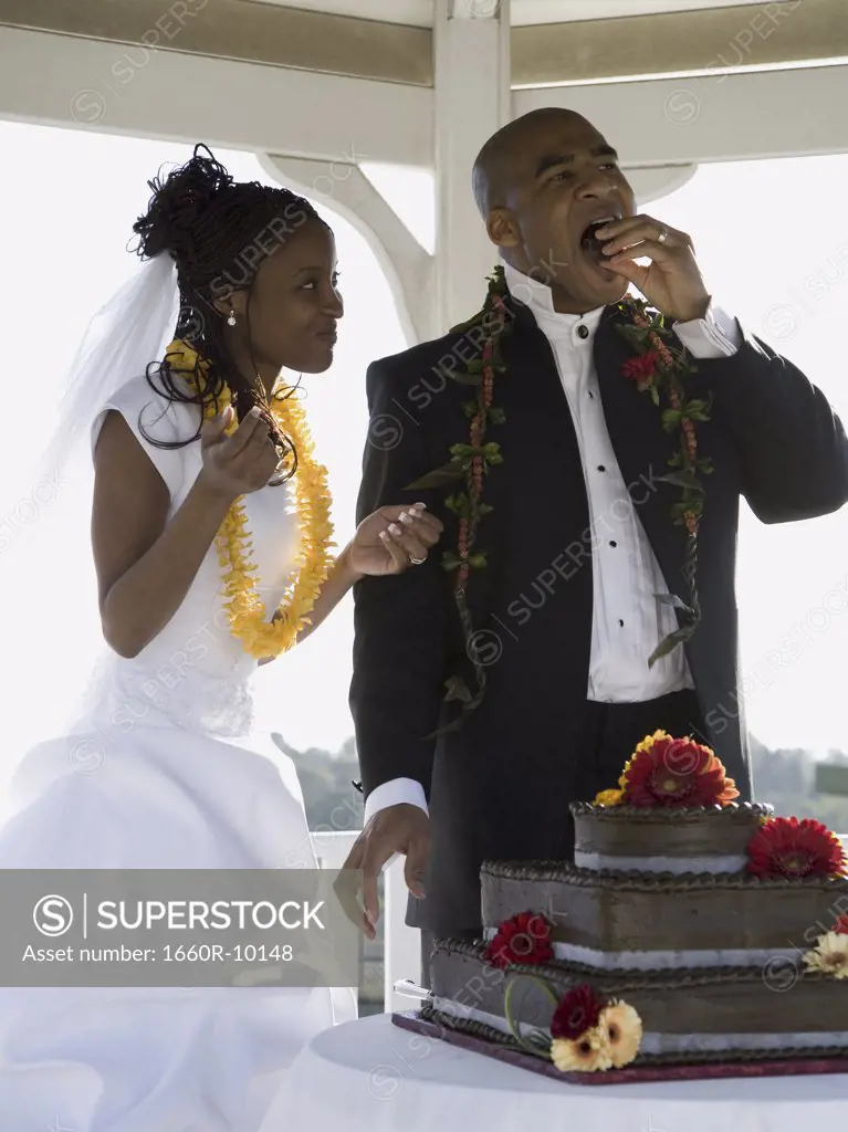 Bride and groom eating their wedding cake