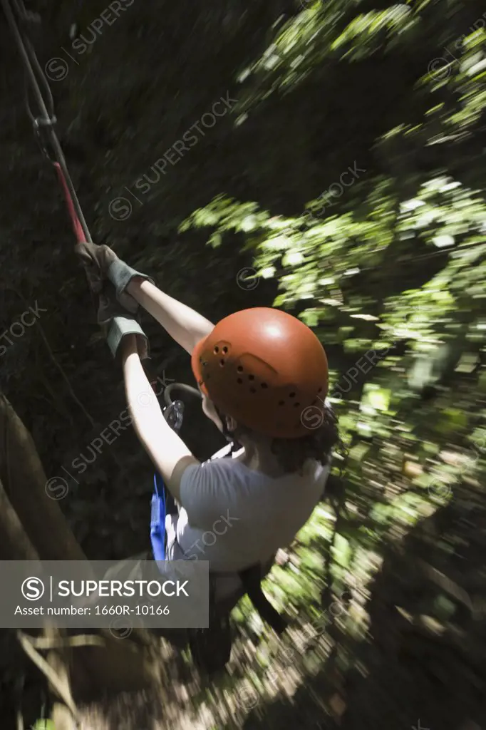 High angle view of a young woman rappelling
