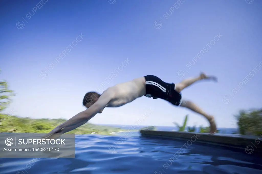 Profile of a young man diving in water