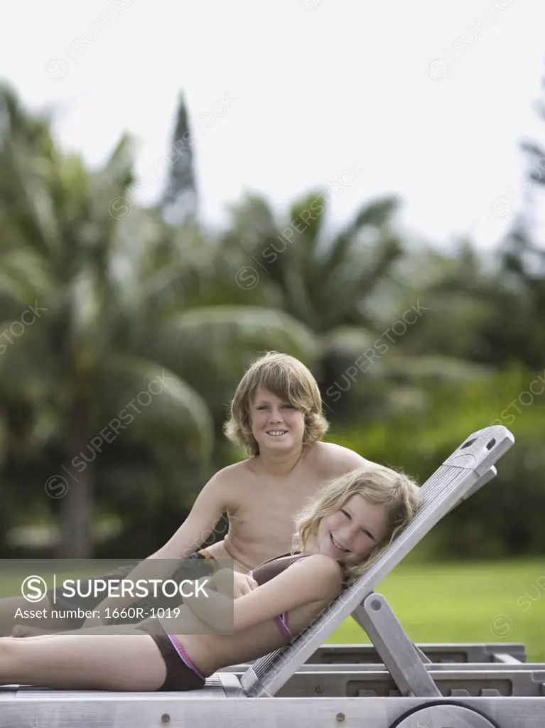 Portrait of two children reclining and smiling