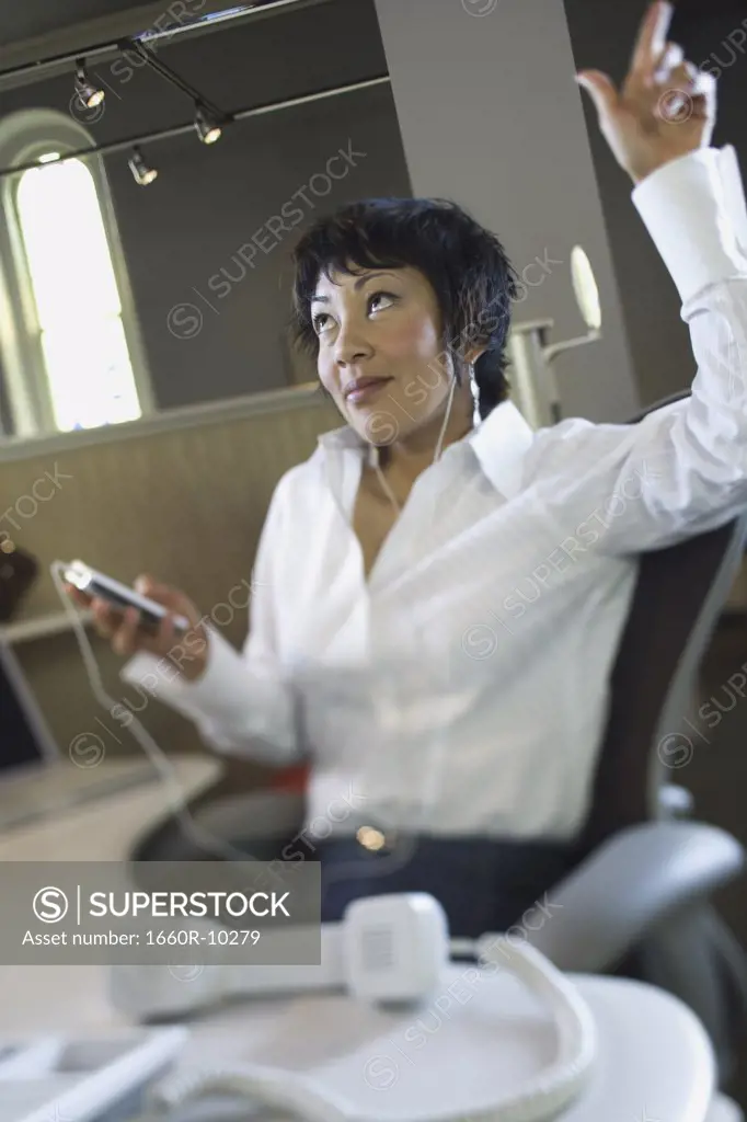 Businesswoman listening to an MP3 player