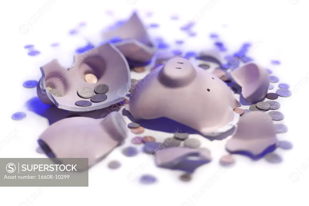 High angle view of a broken piggy bank with coins