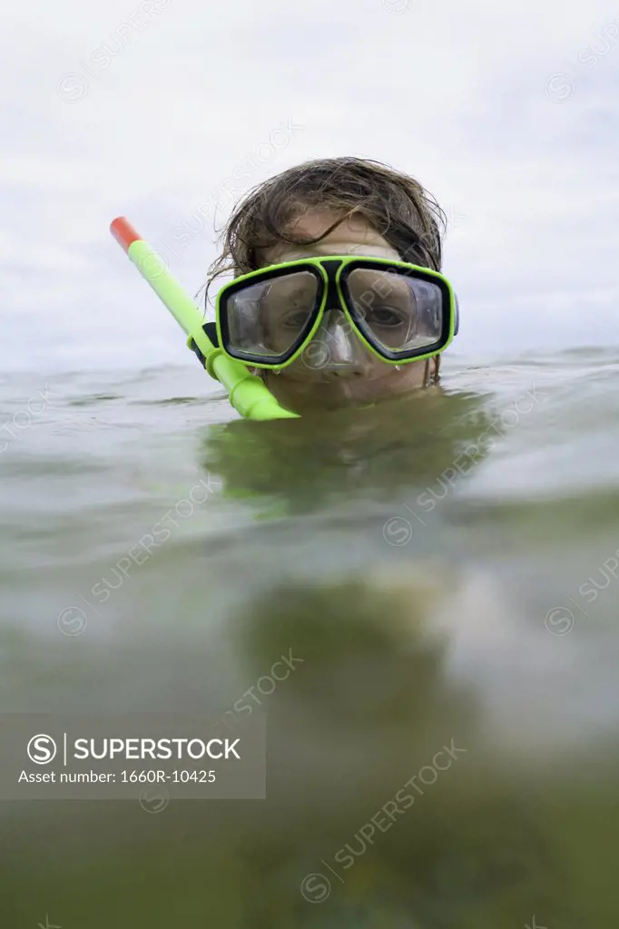 Close-up of a boy wearing a snorkel and swimming goggles
