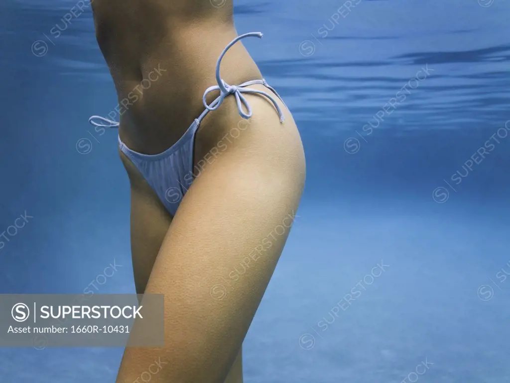 Mid section view of an adult woman underwater
