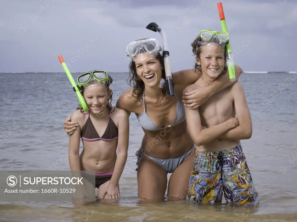 Close-up of a mother and her two children wearing scuba masks and snorkels