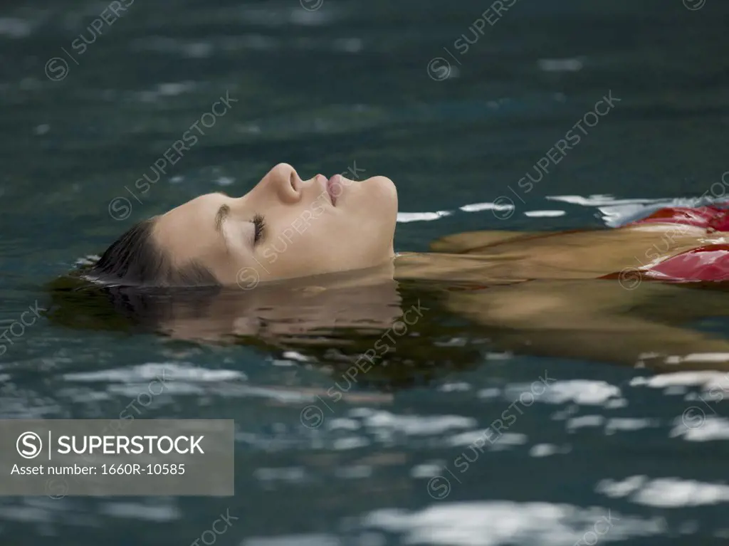 Profile of an adult woman swimming in a swimming pool