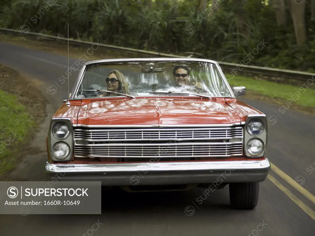 Young couple in a convertible car