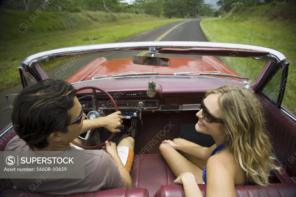 High angle view of a young couple traveling in a car