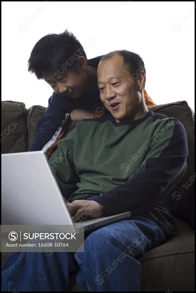 Close-up of a father and his son using a laptop
