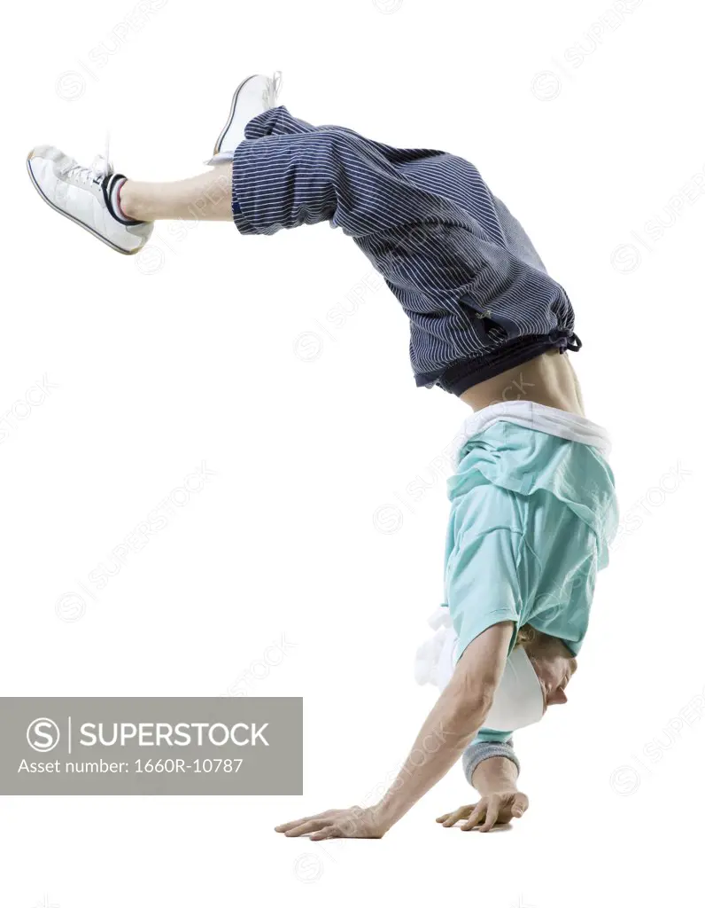 Profile of a young man doing a hand stand
