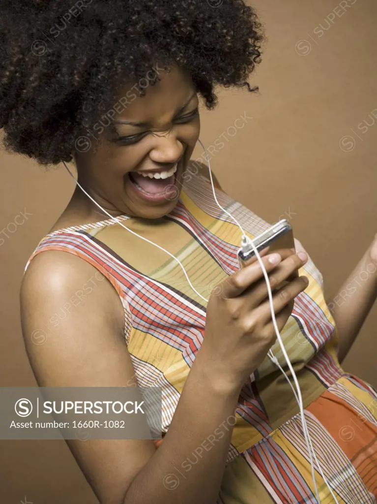 Close-up of a young woman watching a video MP3 player