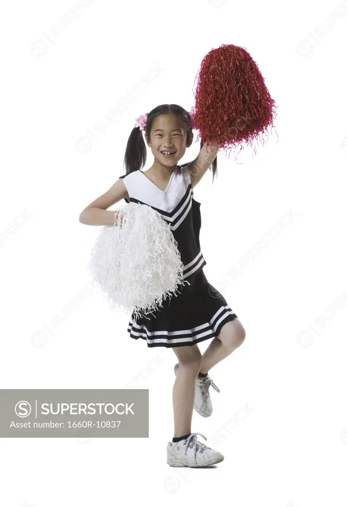 Portrait of a cheerleader dancing with pom-poms