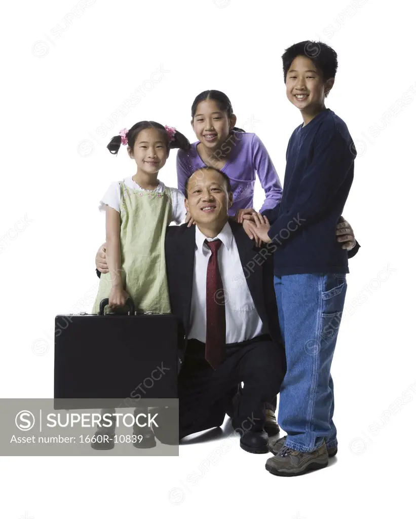 Portrait of a father smiling with his two daughters and son