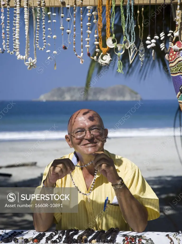 Portrait of a  man selling jewlery on the beach
