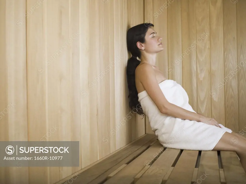 Profile of a young woman relaxing in a sauna
