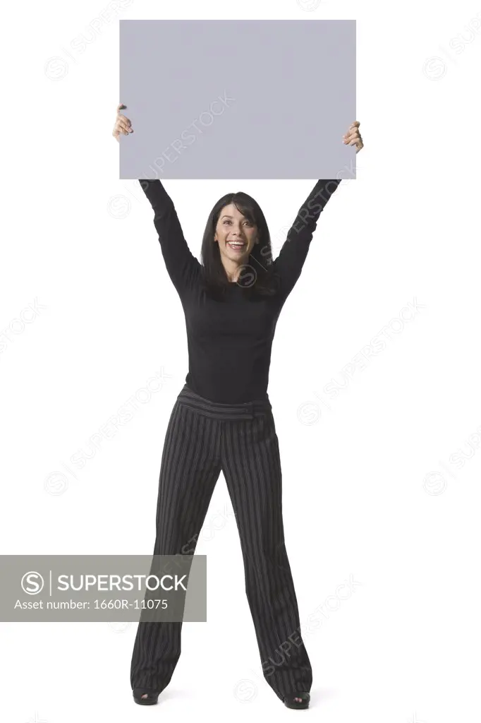 Portrait of a mid adult woman lifting up a placard