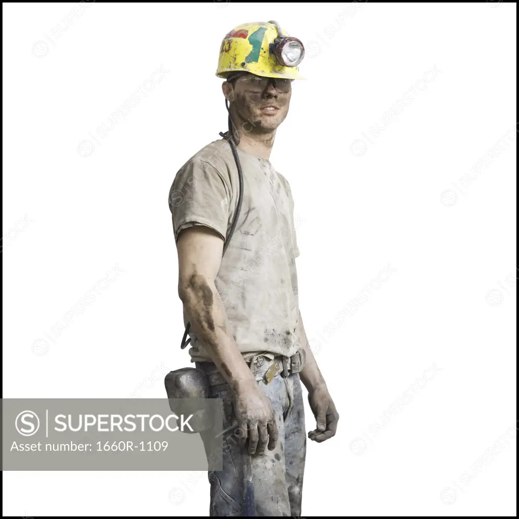Profile of a miner wearing a hardhat with a headlamp
