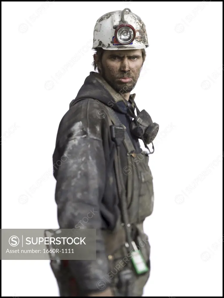 Profile of a miner wearing a hardhat with a headlamp