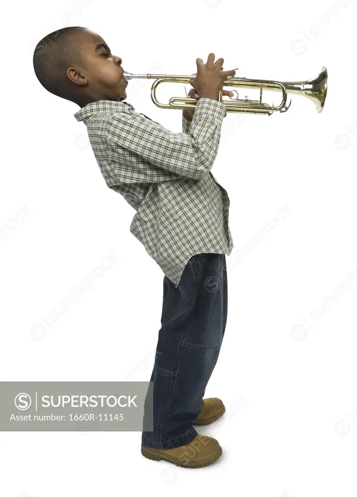 Profile of a boy blowing a trumpet