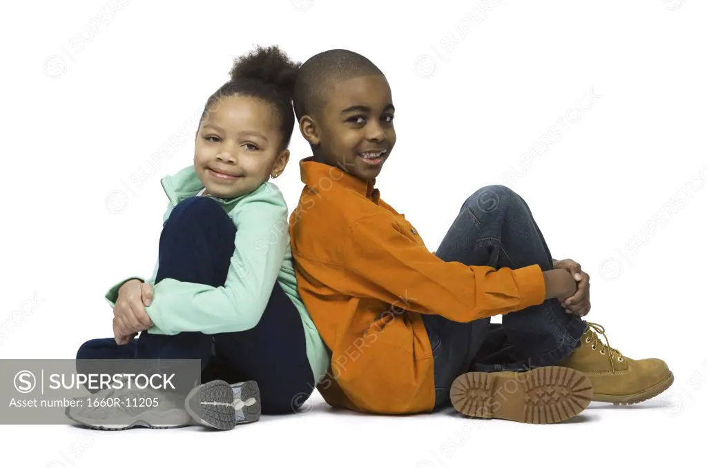 Portrait of a brother and his sister sitting back to back