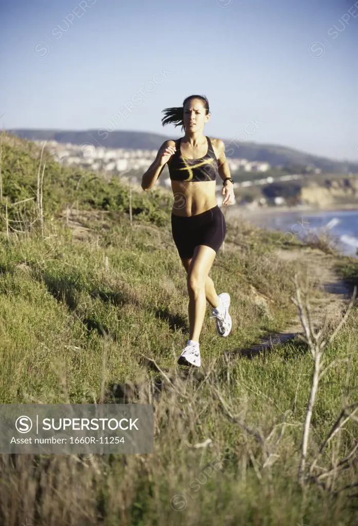 Mid adult woman running