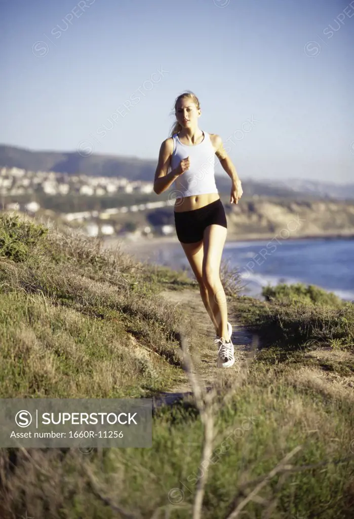 Young woman jogging on the hillside