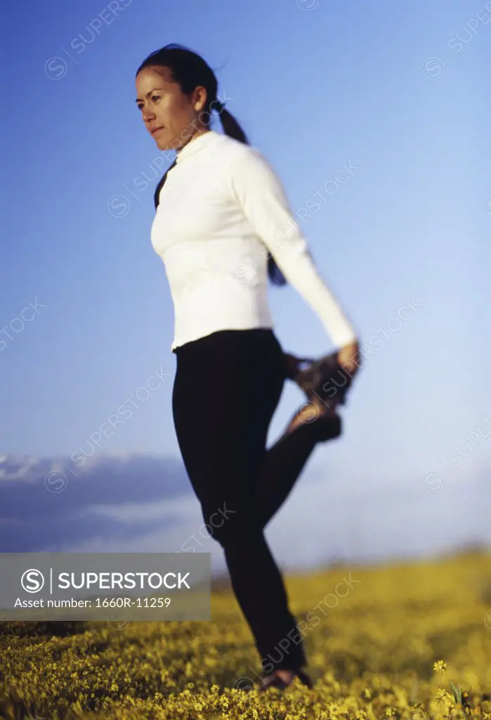 Profile of a young woman exercising