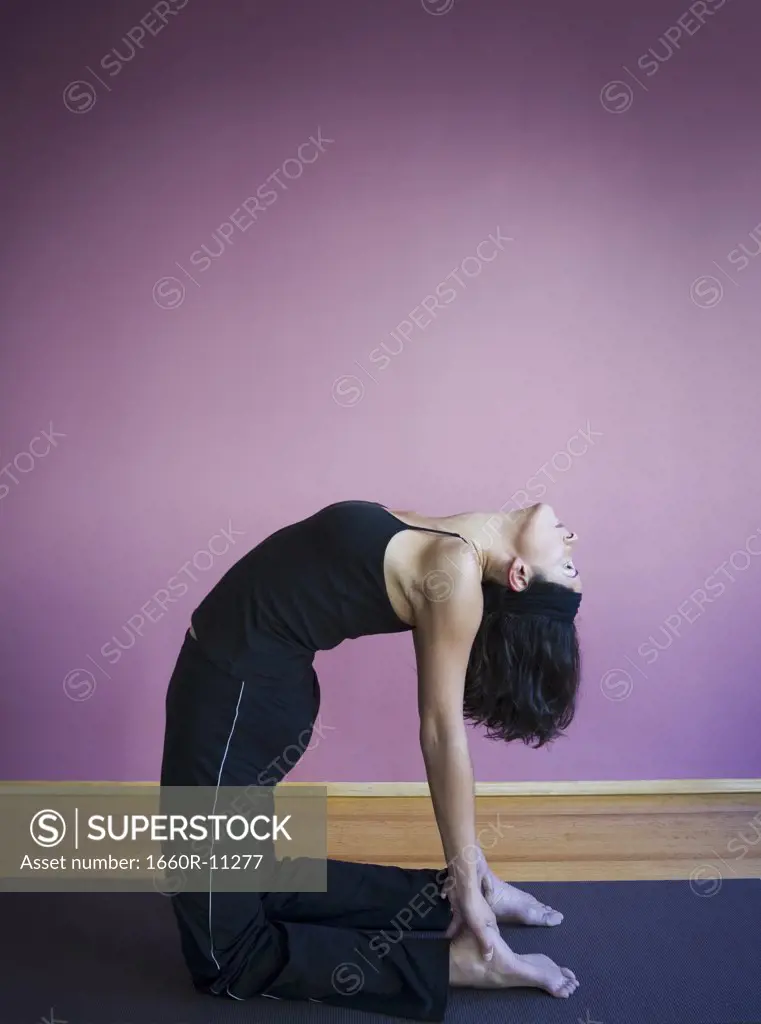 Profile of a young woman bending over her backwards