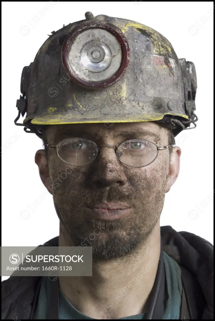 Close-up of a miner wearing a hardhat with a headlamp