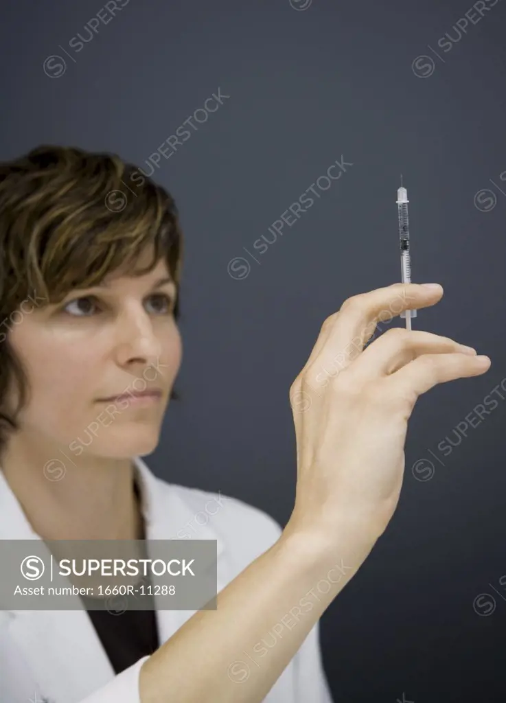 Close-up of a female doctor holding a botox syringe