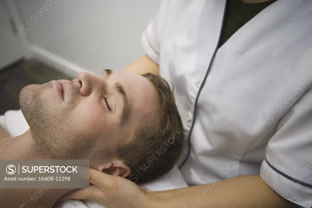 High angle view of an adult man receiving massage