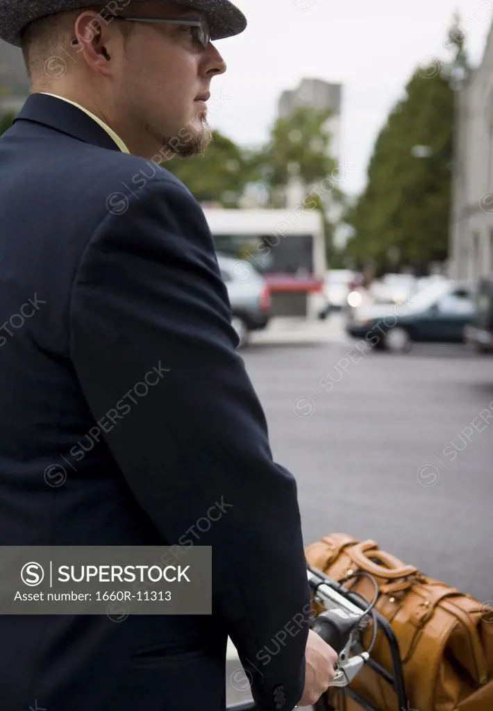 Businessman holding a bicycle