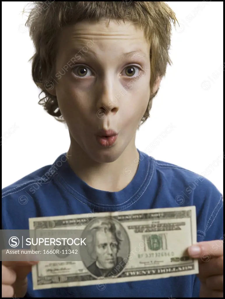 Portrait of a boy holding a twenty dollar bill