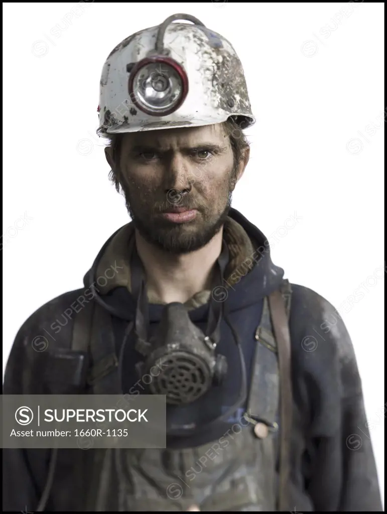 Portrait of a miner wearing a hardhat with a headlamp