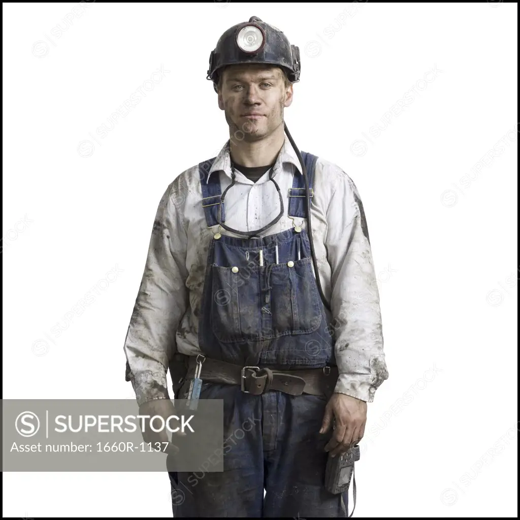 Close-up of a miner wearing a hardhat with a headlamp