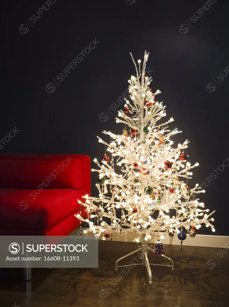 Close-up of a Christmas tree beside a couch