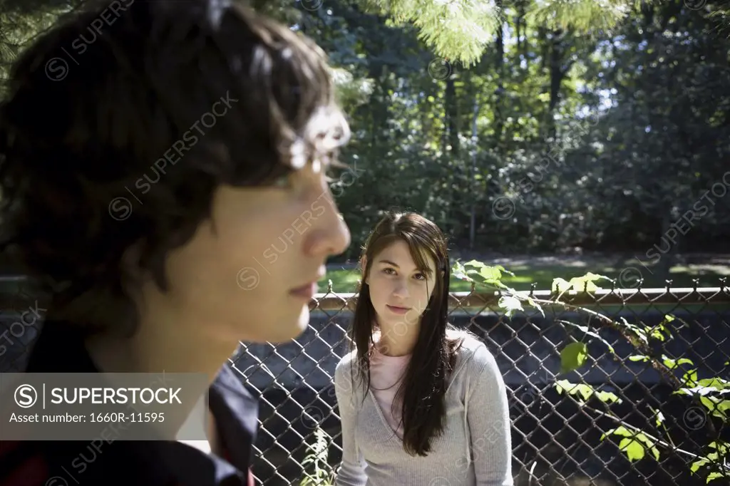Teenage girl looking at a teenage boy