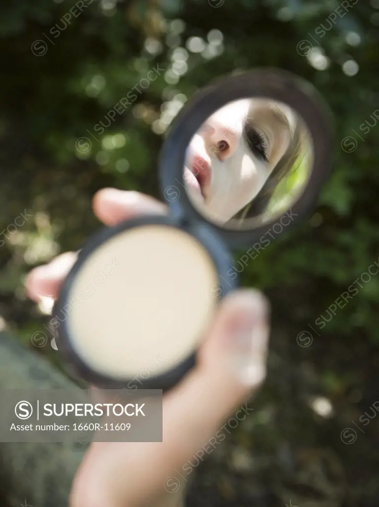 Reflection of a teenage girl in a vanity mirror