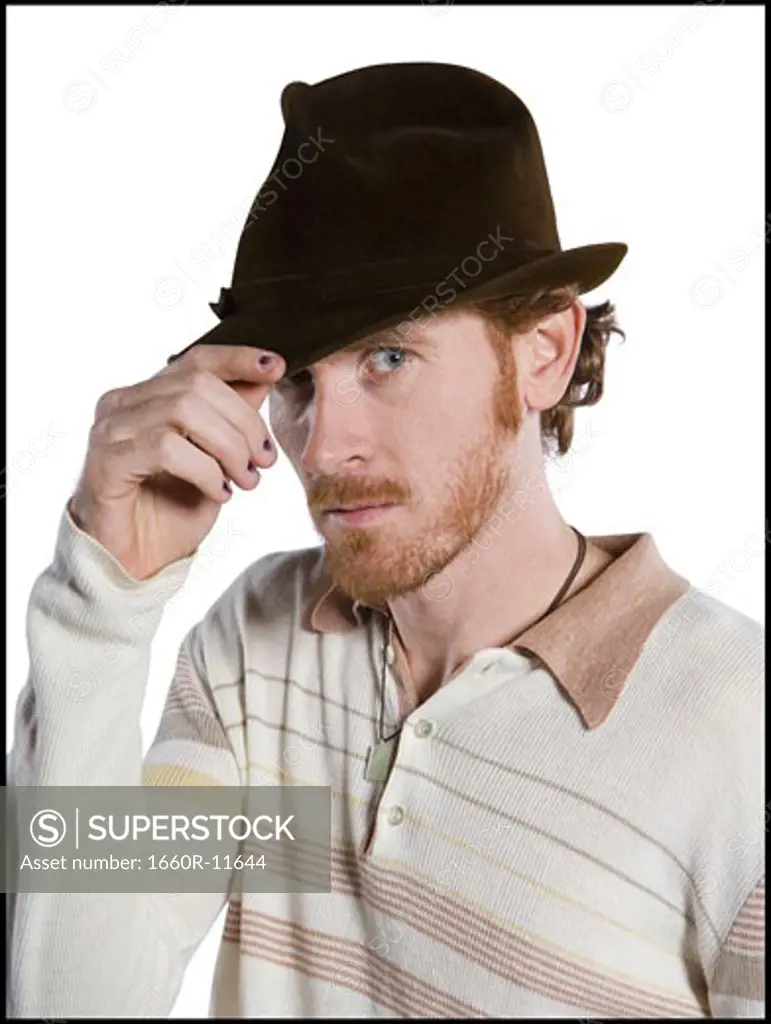Close-up of a mid adult man touching his hat