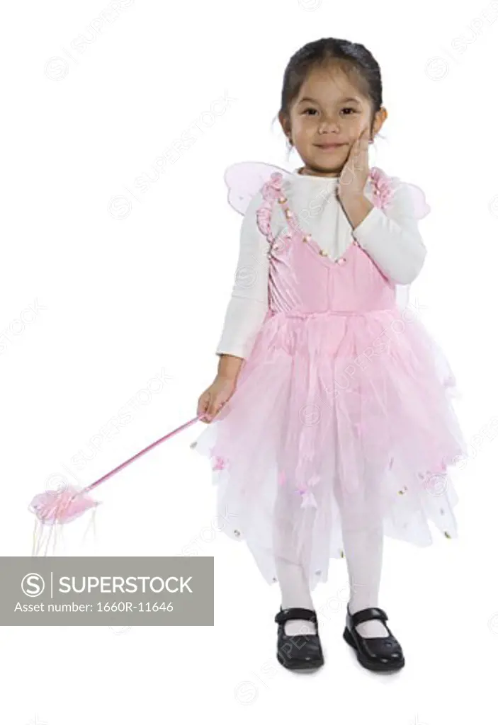Portrait of a girl dressed up in a fairy costume holding a magic wand