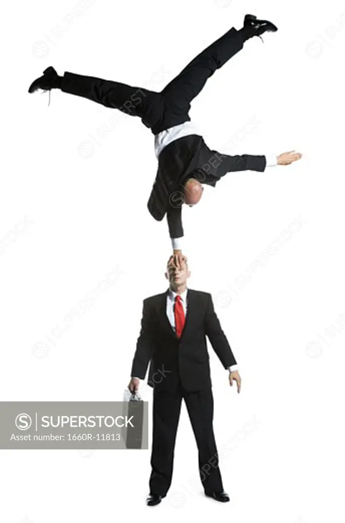 High angle view of two male acrobats in business suits performing