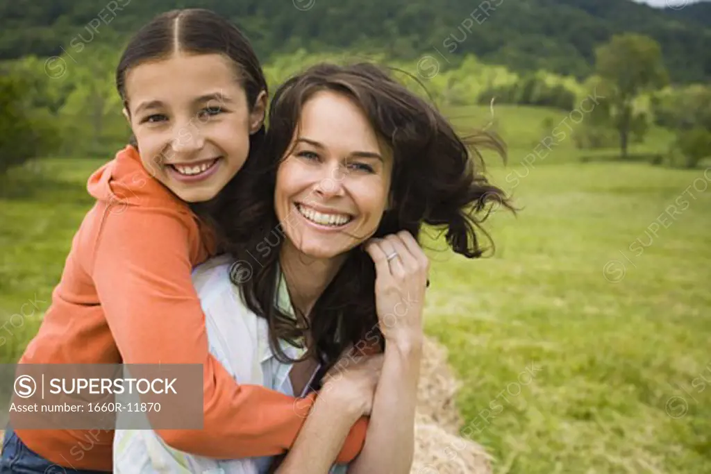 Portrait of a girl hugging her mother from behind