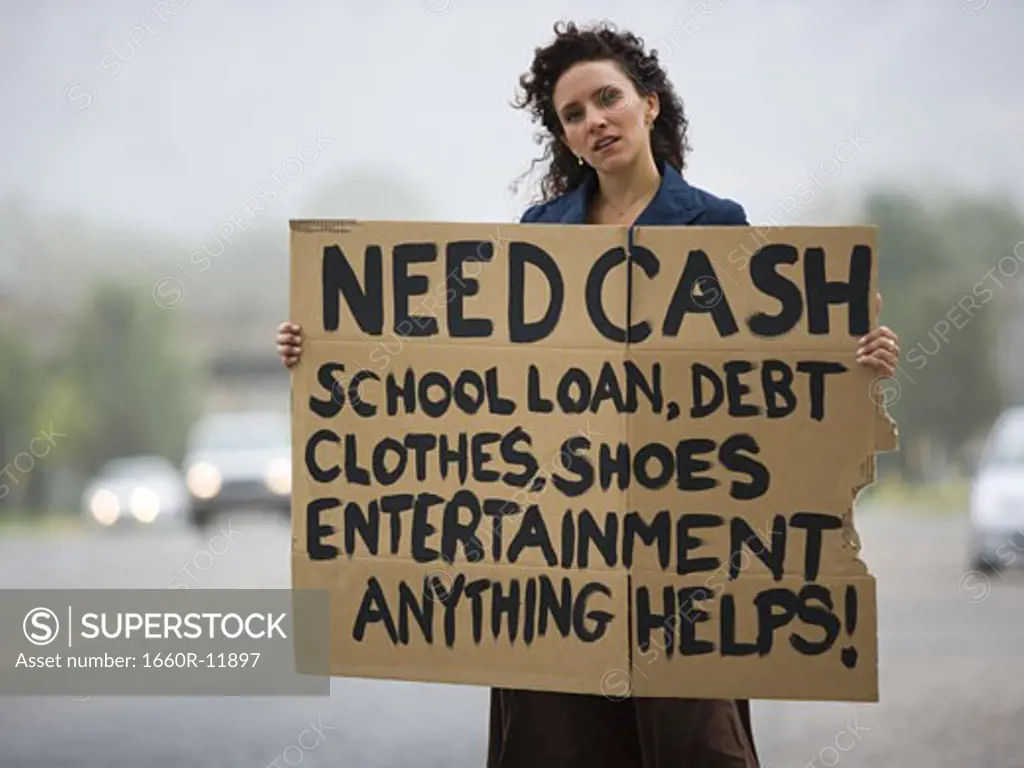 A young woman holding a help-needed sign