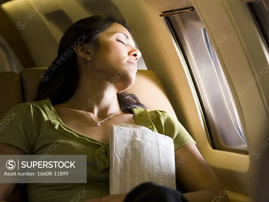 A woman sleeping in an airplane