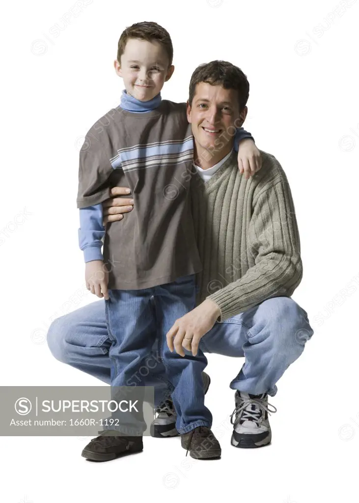 Portrait of a father and his son with their arms around each other