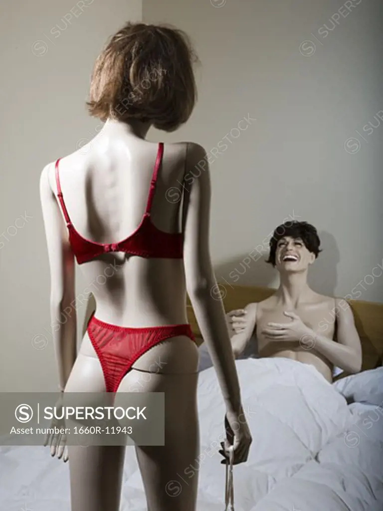 Two mannequins portraying a heterosexual couple in the bedroom