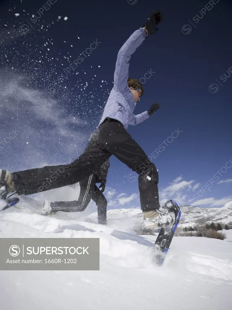 Low angle view of two women on snowshoes