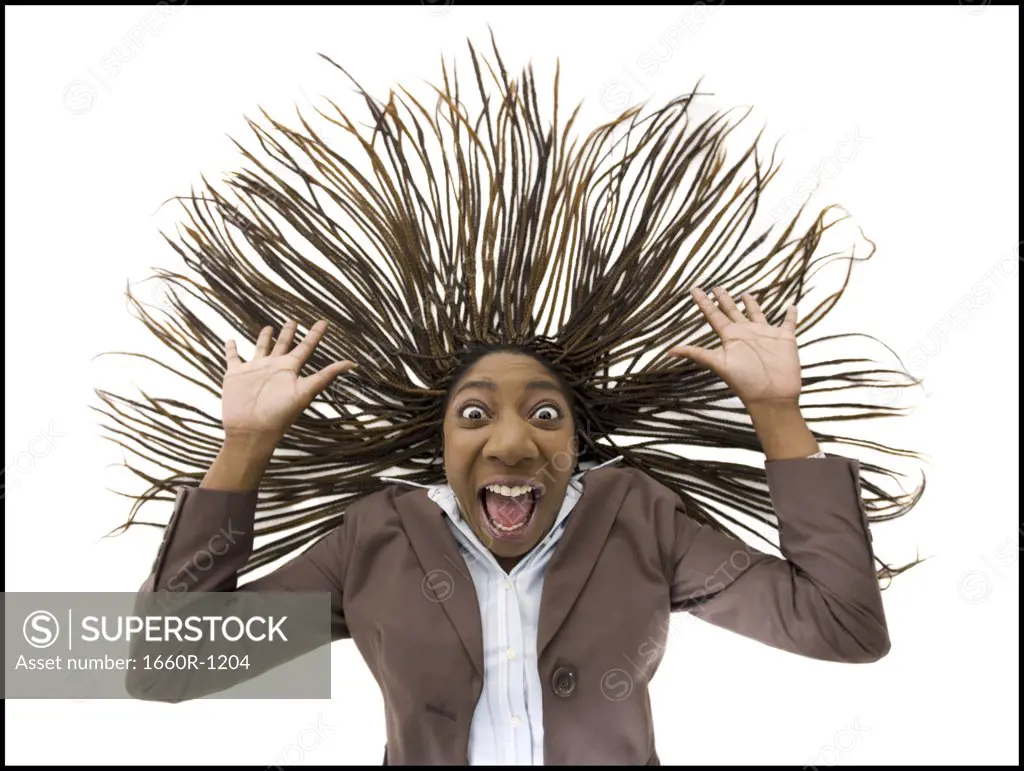 Portrait of a businesswoman shouting with her arms raised